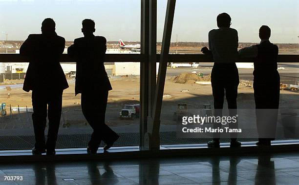 Onlookers watch as an Air India jetliner taxis at John F. Kennedy International Airport after authorities determined that a suspicious passenger was...