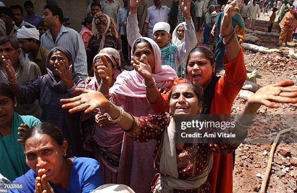 Muslims beg members of the news media and the Indian Rapid Reaction Force Police to protect them from a mob of Hindu neighbors that were attacking...