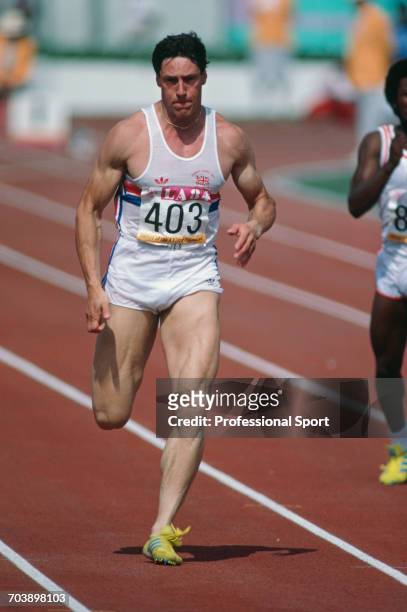 Scottish track athlete Allan Wells competes for Great Britain in the heats to reach the semifinals of the Men's 100 metres event inside the Memorial...