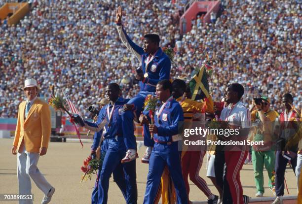 American track athlete Carl Lewis is held aloft by his teammates Sam Graddy and Ron Brown after the United States Men's 4 x 100 metres relay team...