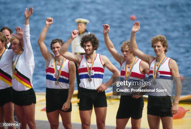 View of the Great Britain Men's coxless four rowing team of John Beattie, Ian McNuff, David Townsend and Martin Cross pictured waving on the medal...