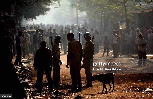 Indian police block a mob of Hindus from attacking Muslims March 1, 2002 in Ahmadabad, India. Indian troops arrived in the riot-torn western state of...