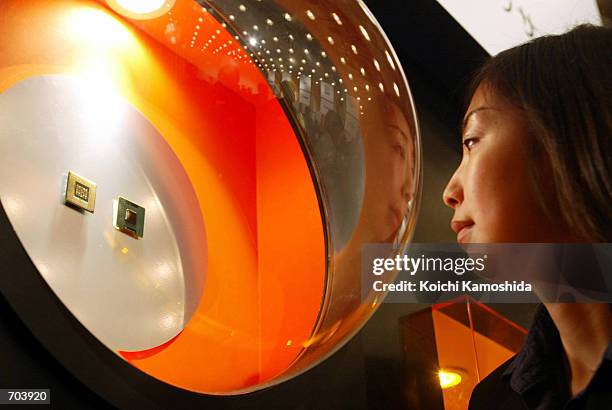 Japanese woman looks at The IntelR PentiumR 4 processor during a press conference March 1 2002 in Tokyo, Japan. The worlds top computer chip maker,...