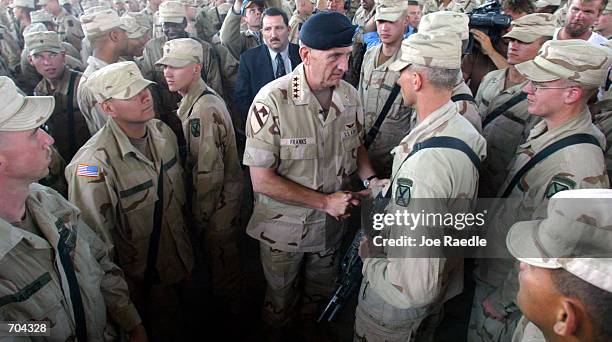 Army General Tommy Franks shakes hands with soldiers from the 10th Mountain Division after announcing that Operation Anaconda will end within 12...