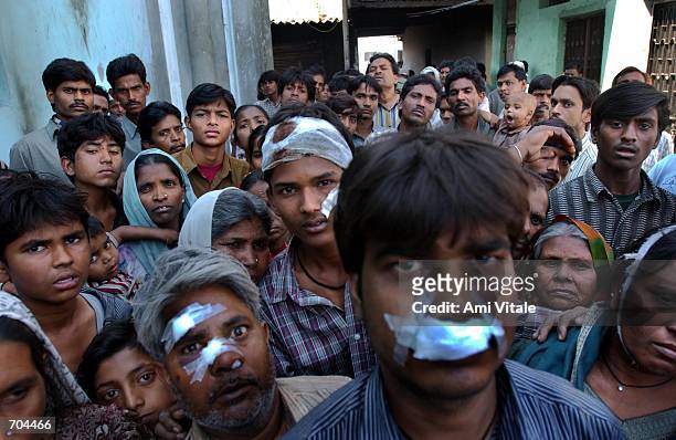 Muslims, who had begged police to protect them the day before, sit huddled in the wreckage of their burned out homes after a mob of Hindu neighbors...