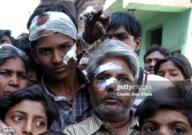 Muslims, who had begged police to protect them the day before, sit huddled in the wreckage of their burned out homes after a mob of Hindu neighbors...