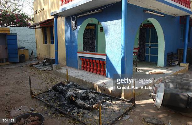 An elderly Muslim womans body, whose face and throat was slashed and then set on fire, lies outside of her home March 2, 2002 in Ahmadabad, India....