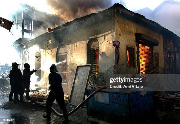 Indian firemen attempt to put out a rapidly spreading fire March 3, 2002 in a Muslim neighborhood of central Ahmadabad, India. Over 500 people are...