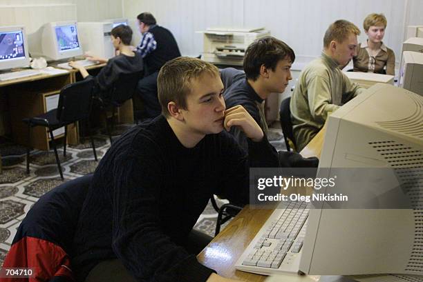 Teenagers play computer games at an Internet cafe March 3, 2002 in Novosibirsk, East Siberia, Russia. Many Russian teenagers have no home computers...