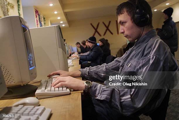 Teenager plays a computer game at an Internet cafe March 3, 2002 in Novosibirsk, East Siberia, Russia. Many Russian teenagers have no home computers...