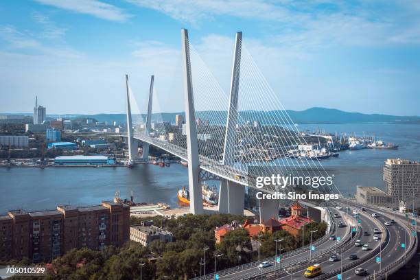 zolotoy bridge under blue sky - vladivostok stock pictures, royalty-free photos & images