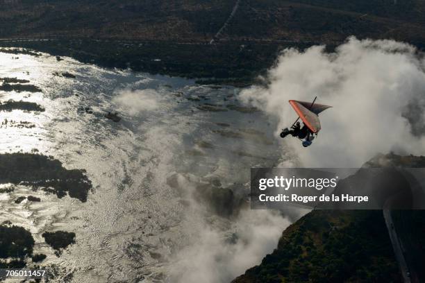 aerial view of a micorlight (ultralight) flying over the zambezi river and victoria falls. livingstone. zambia - victoria falls stock pictures, royalty-free photos & images