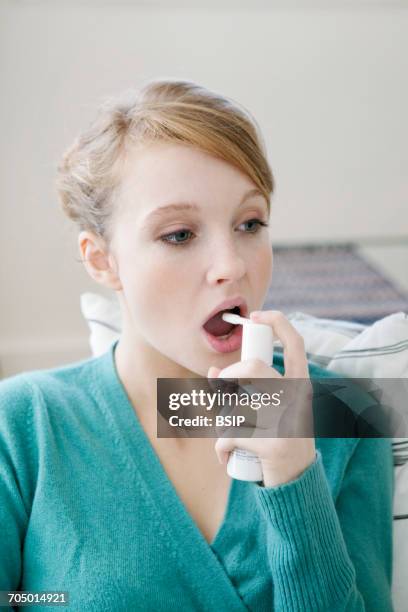 woman using spray in mouth - mouth spray stock pictures, royalty-free photos & images