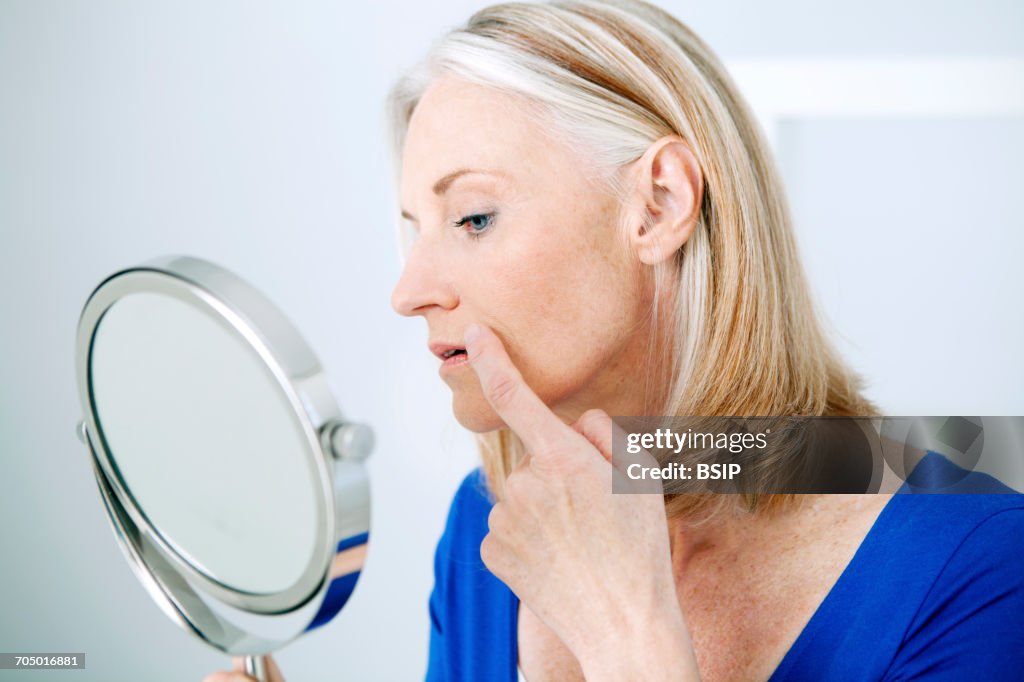 Elderly person with mirror