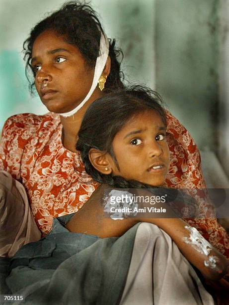 Naza Banu and her daughter Hina who were injured after an attack by a Hindu mob sits inside a mosque March 5, 2002 in central Ahmadabad, India. Over...