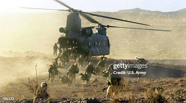 Army soldiers from the 101st Airborne division off load during a combat mission from a Chinook 47 helicopter March 5, 2002 in Eastern Afghanistan....