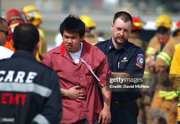 Rescuers care for a "victim" during an FAA-required triennial emergency exercise at John Wayne Airport March 6, 2002 in Santa Ana, CA. Some 300...