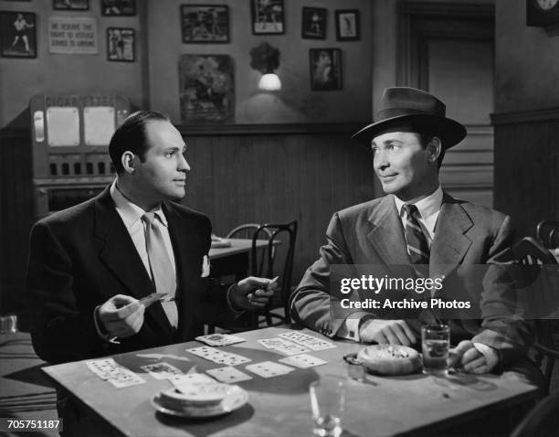 American actors Richard Karlan as Sy, and Barry Sullivan as Steve Keiver in a publicity still for 'No Questions Asked ', directed by Harold F. Kress,...