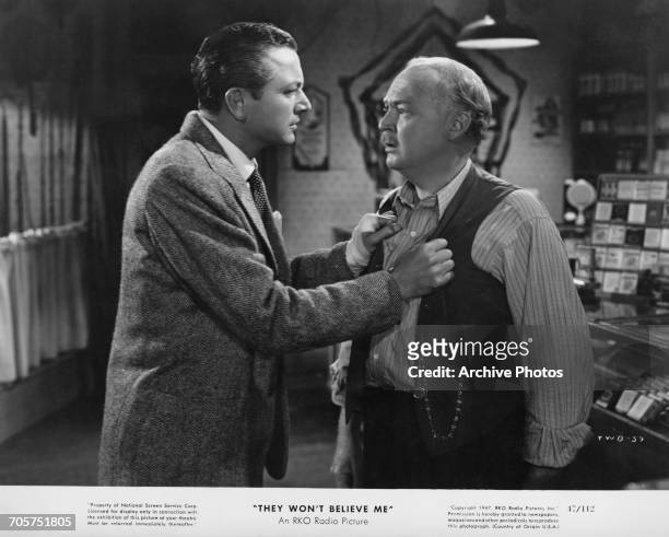 American actors Robert Young , and Don Beddoe in a publicity still for Irving Pichel's film noir, 'They Won't Believe Me', 1947.