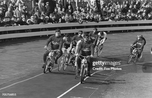 Spectators look on as Derny bikes lead the racing cyclists into the 20 lap Kerin race start at the Herne Hill Velodrome on 4 April 1969 at Herne...