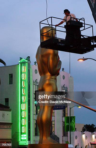 Giant Oscar award statue is erected at the beginning of the red carpet arrivals area as final preparations are made March 21 in Hollywood, CA for the...