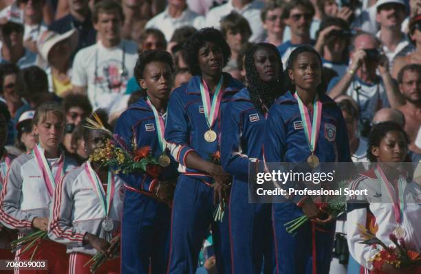 American track athletes, from left, Alice Brown, Jeanette Bolden, Chandra Cheeseborough and Evelyn Ashford of the United States team stand together...