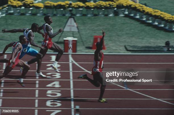 Canadian track athlete Ben Johnson crosses the finish line in first place to win the gold medal in the final of the Men's 100 metres event, with Carl...