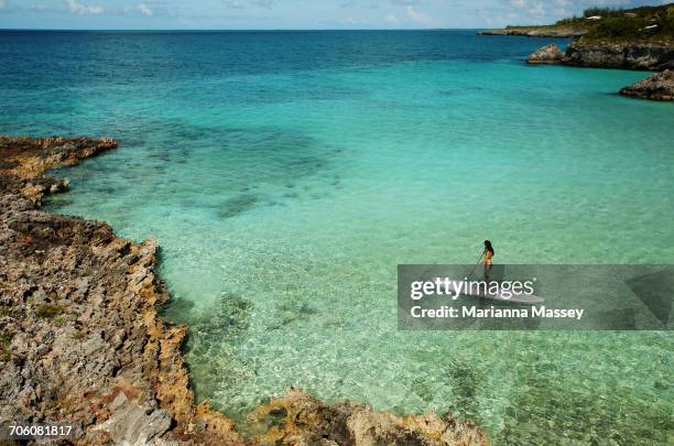 a woman paddle boards in the caribbean - 2016 25-29 stock pictures, royalty-free photos & images