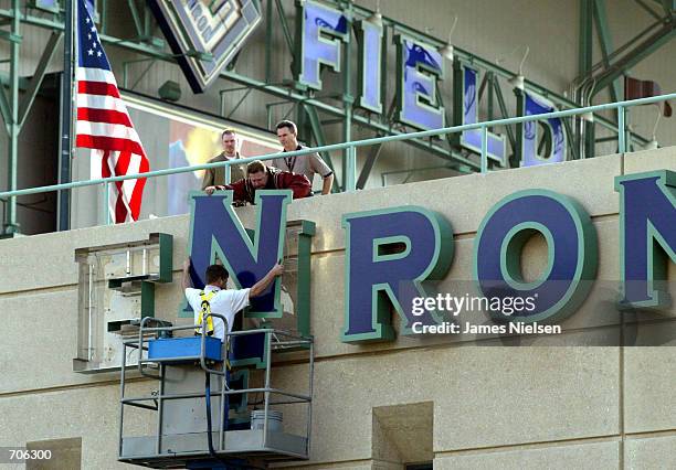 Stadium employees remove letters from one of the Enron Field signs March 21, 2002 in Houston, TX. The Houston Astros paid $2.1 million to get back...