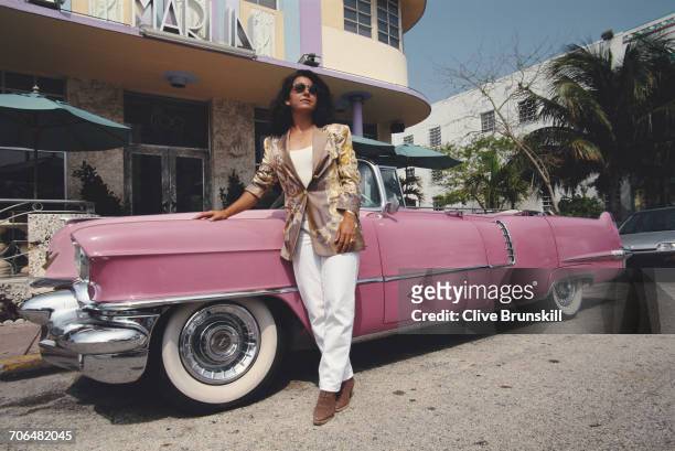 Arantxa Sanchez Vicario of Spain poses for a portrait beside a Pink Cadillac car outside The Marlin Hotel before the ATP Lipton International Players...