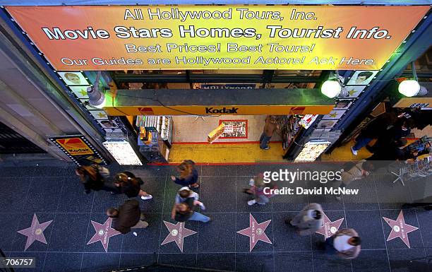 Pedestrians pass a business, across the street from the Kodak Theatre, which caters to tourists with momentos and Hollywood tours March 22 in...