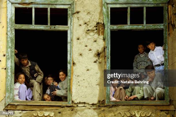 Afghan boys attend their first class on the first day of the official school year March 23, 2002 at the Amir Dost Mohammad Khan Secondary School in...