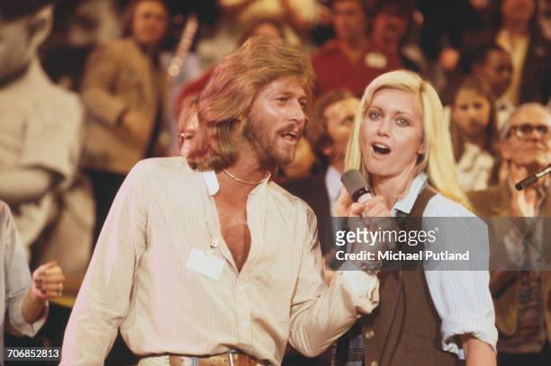 British singer Barry Gibb of The Bee Gees performs live on stage with singer and actress Olivia Newton-John at 'The Music for UNICEF Concert: A Gift...