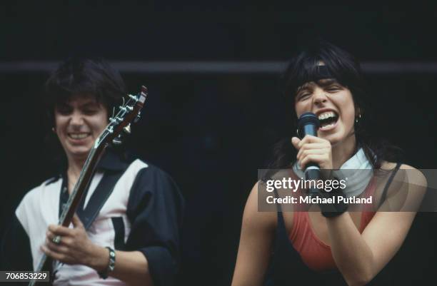 German singer Nena performing with guitarist Carlo Karges from her band of the same name, at Werchterpark, Werchter, Belgium, 10th June 1983.
