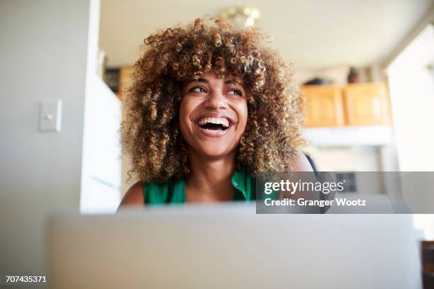 laughing black woman using laptop - low angle view home stock pictures, royalty-free photos & images