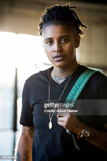 portrait of androgynous mixed race woman carrying backpack - androgynous stock pictures, royalty-free photos & images