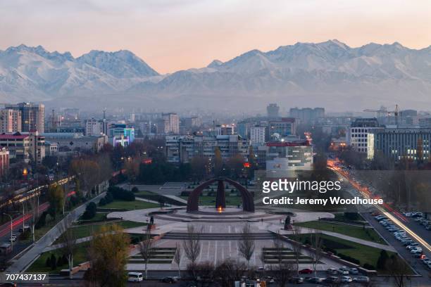 victory square near kyrgyz range at dusk, bishkek, frunze, kyrgyzstan - bishkek stock pictures, royalty-free photos & images