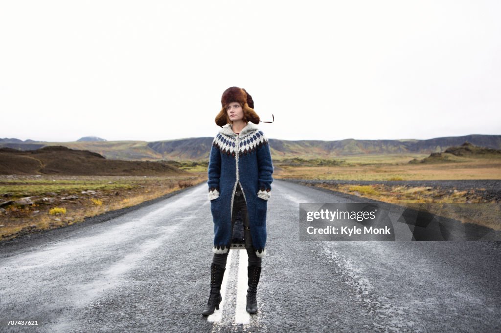 Caucasian woman standing in middle of road