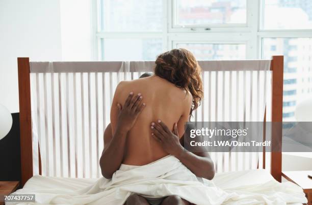 woman and man hugging in bed - lwa dann tardif bed stock pictures, royalty-free photos & images