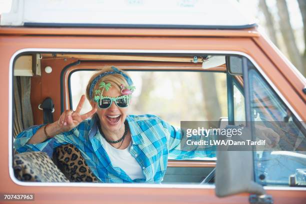 smiling caucasian woman driving camper van - physical stance stock-fotos und bilder