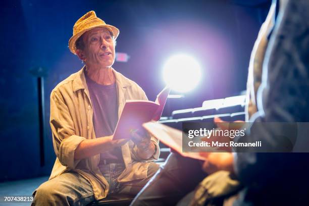 caucasian actors rehearsing with scripts in theater - actress rehearsing stock pictures, royalty-free photos & images