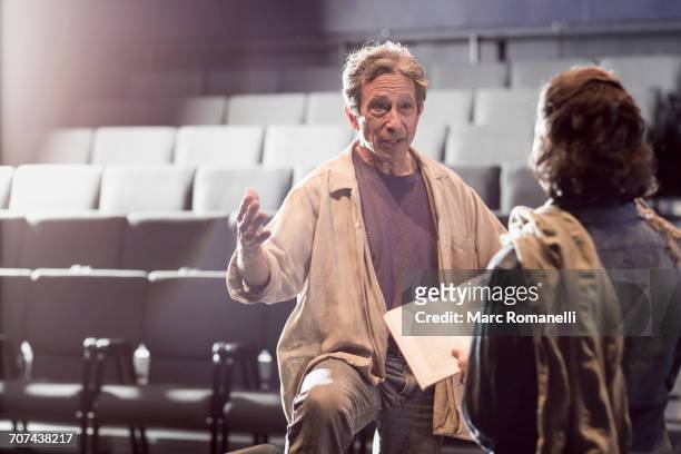 caucasian actors rehearsing with script in theater - actor chair stock pictures, royalty-free photos & images