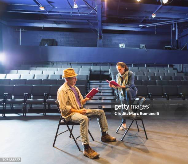 caucasian actors rehearsing with scripts in theater - actor stage stock pictures, royalty-free photos & images