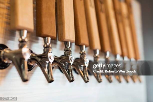 close up of beer taps - bier zapfhahn stock-fotos und bilder