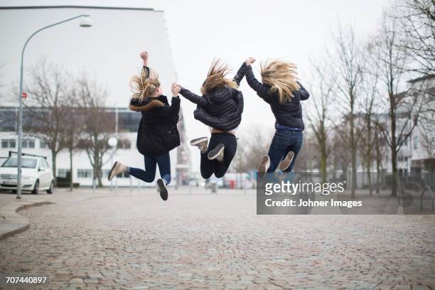 girls jumping together - helsingborg if stock pictures, royalty-free photos & images