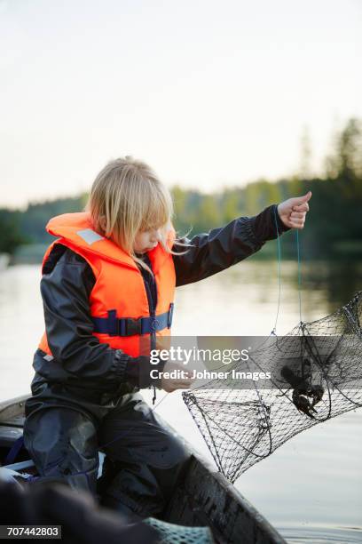 girl with crayfish trap - crawfish stockfoto's en -beelden