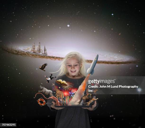 caucasian girl imagining adventures in outer space - gruppe springen ipad stock-fotos und bilder
