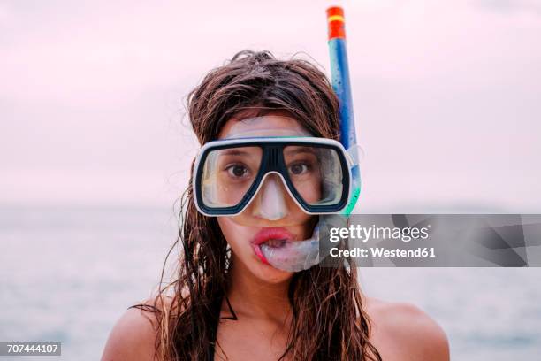 young woman with diving goggles and snorkel pulling funny faces - funny situation woman imagens e fotografias de stock