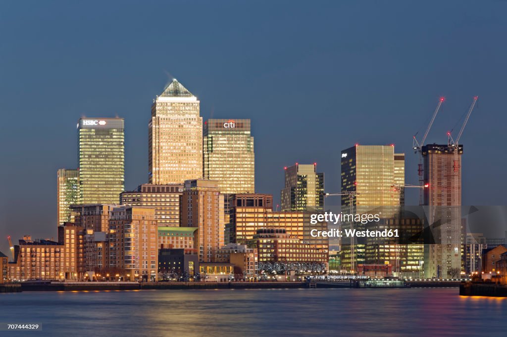 UK, London, skyline of Canary Wharf at River Thames at dusk