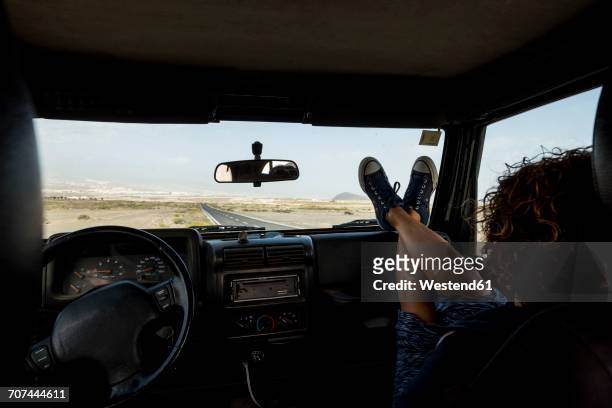 woman sitting in car with feet up on dashboard - independece stock pictures, royalty-free photos & images